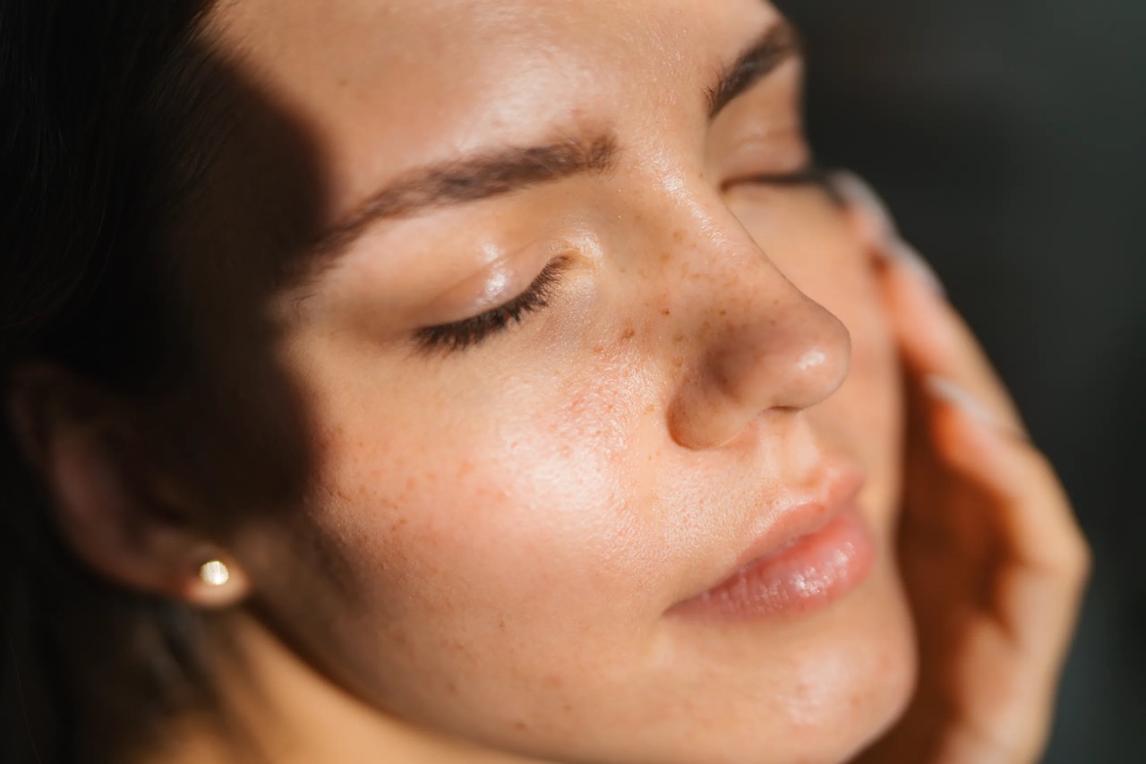 Close-up portrait showing detailed skin, hair, and shadows