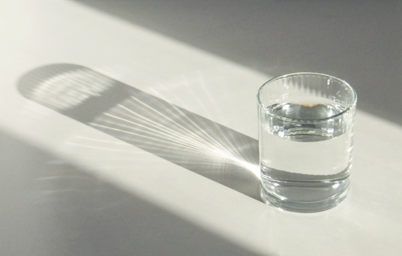 Glass of water casting detailed light and reflections