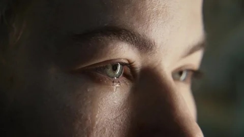 Close-up cinematic frame of a face with changing light and motion