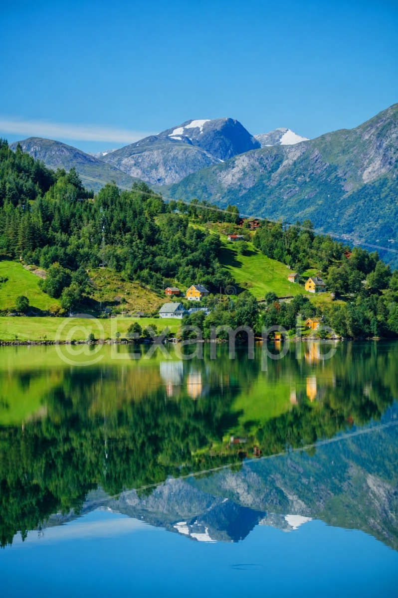 Mountain lake with a faint @Example text watermark