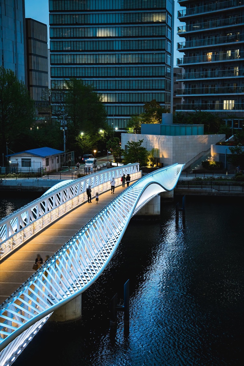 Illuminated bridge with an animated semi-transparent @Example watermark